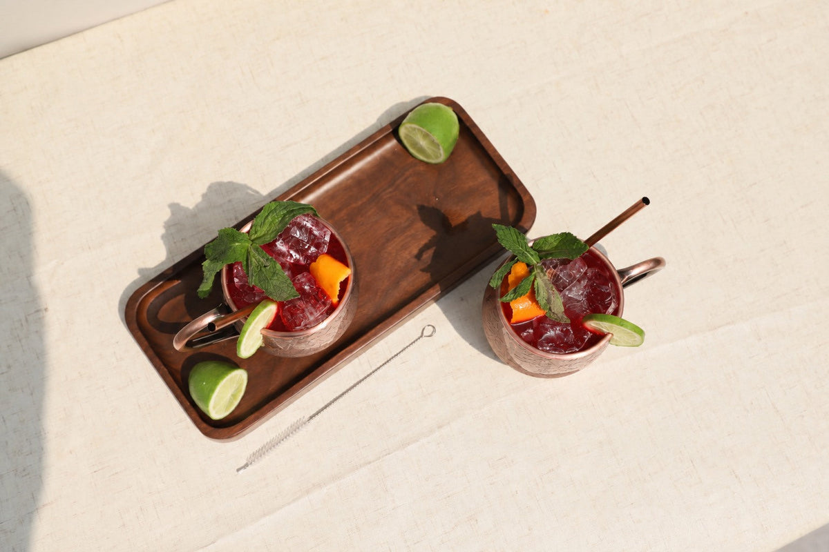 Cranberry Moscow mules with frozen cranberries and rosemary on an autumn Thanksgiving table