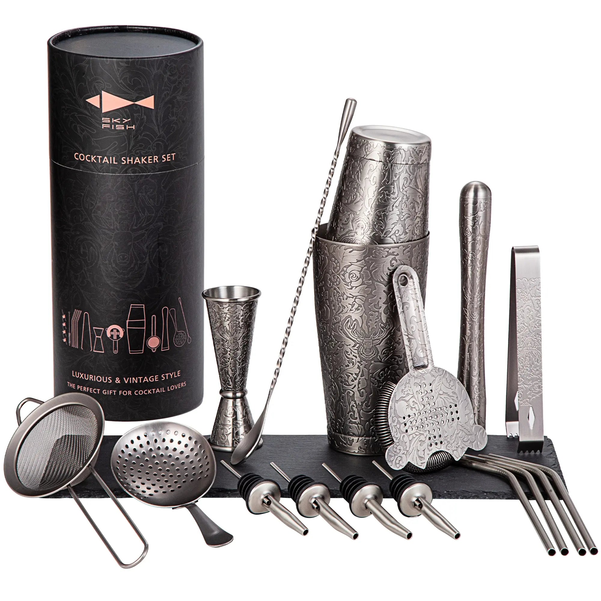 Cocktail shaker set with various tools and a black cylindrical packaging on a white background