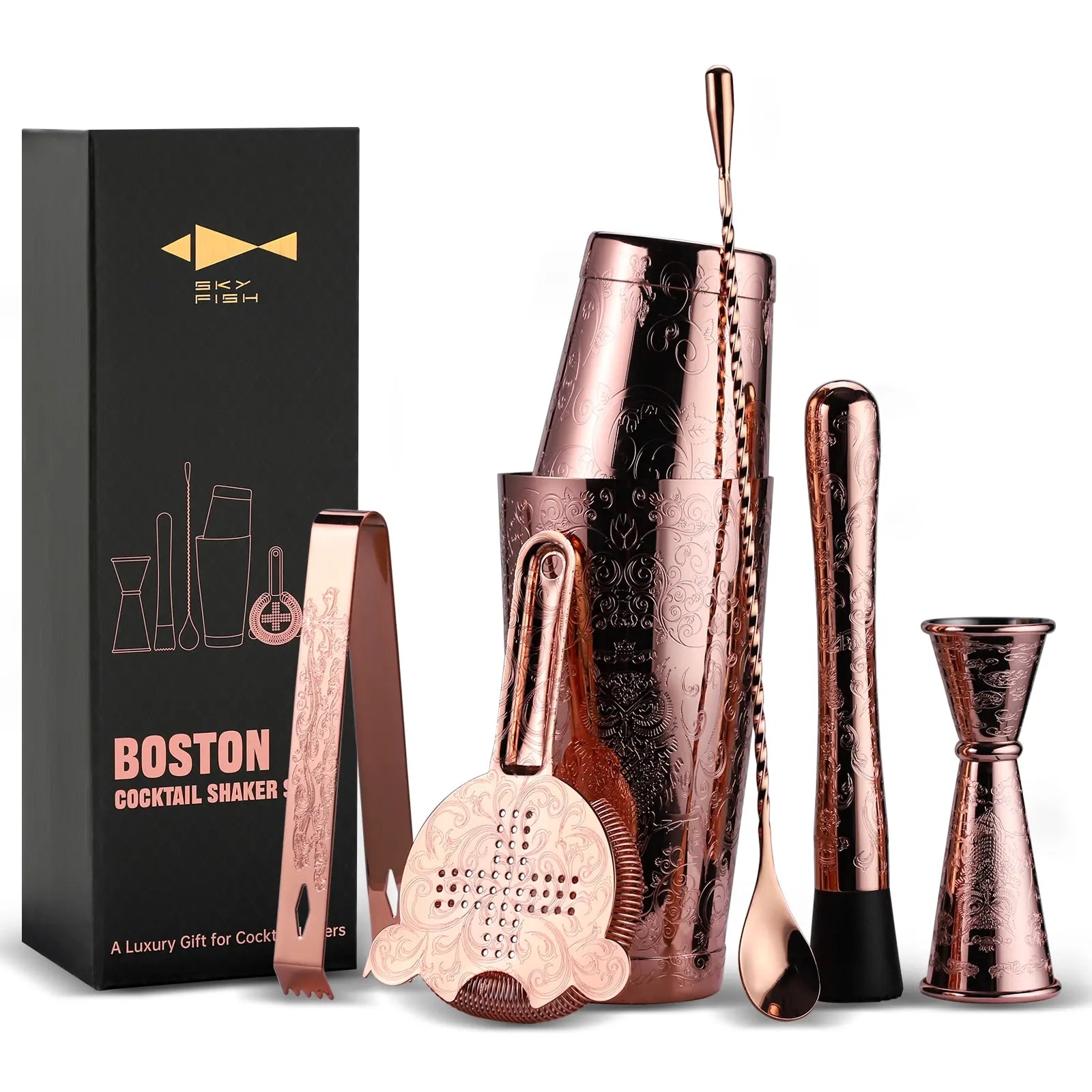 Copper cocktail shaker set with tools and packaging on a white background